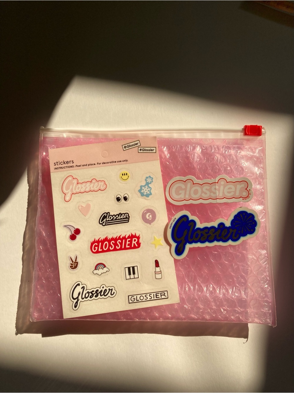 Glossier bag and sticker bundle